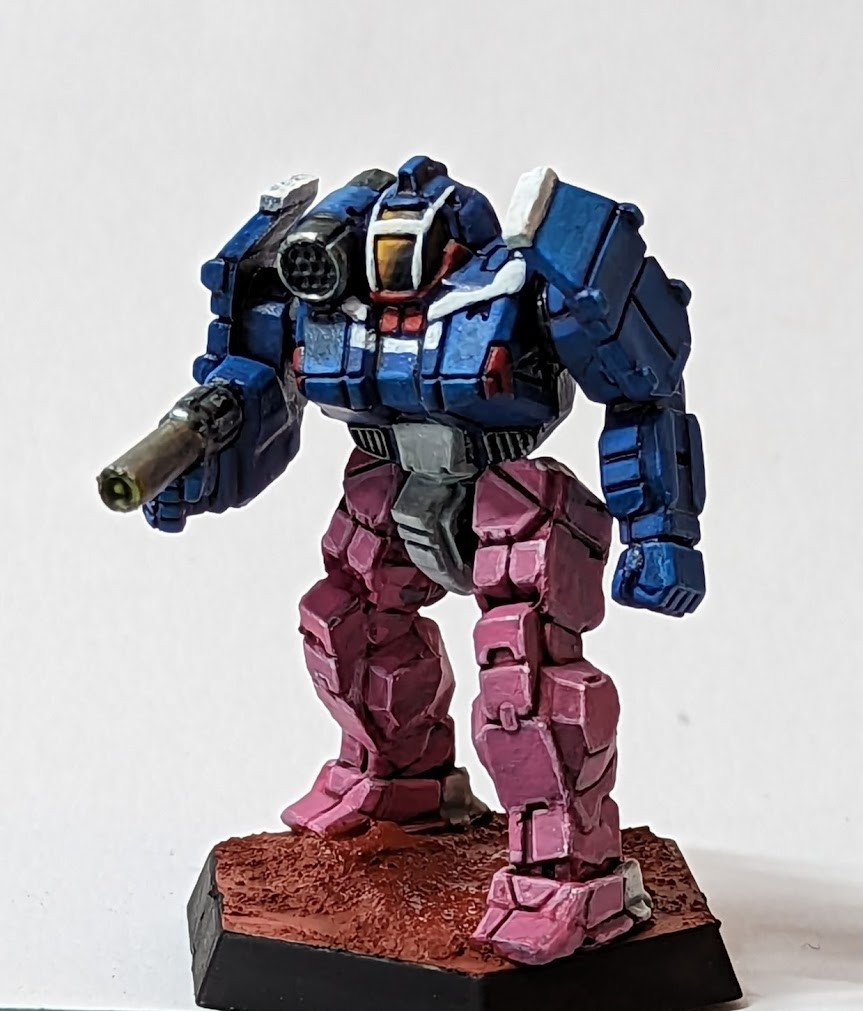 A photo of a Battletech mini painted in the colours of Nene's armour from Bubblegum Crisis.