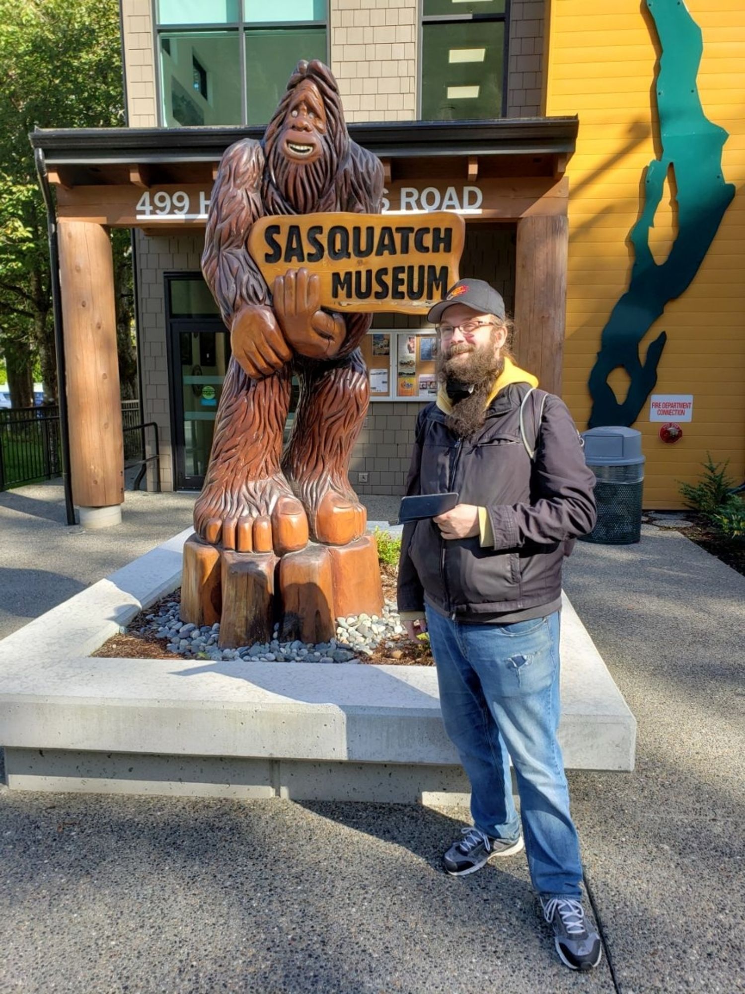 I'm posing in front of a statue of bigfoot holding the "Sasquatch Museum" sign in Harrison Hot Springs. The museum is also the visitor centre :)