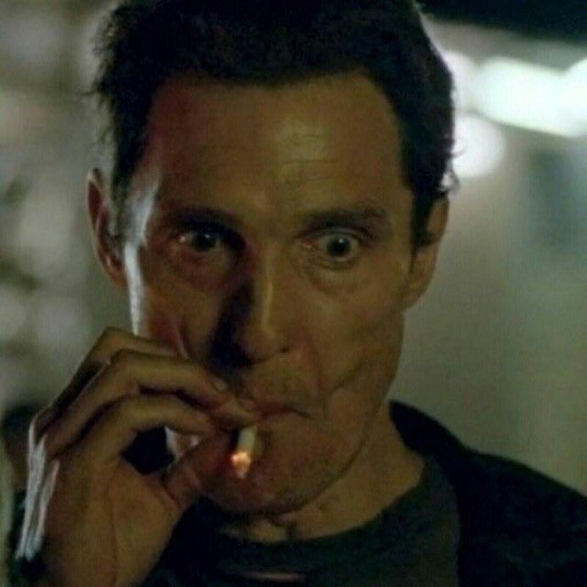 Matthew McConaughey puffing from a cigarette meme image with his eyes bugged out, and he's looking down at something he's intently watching.