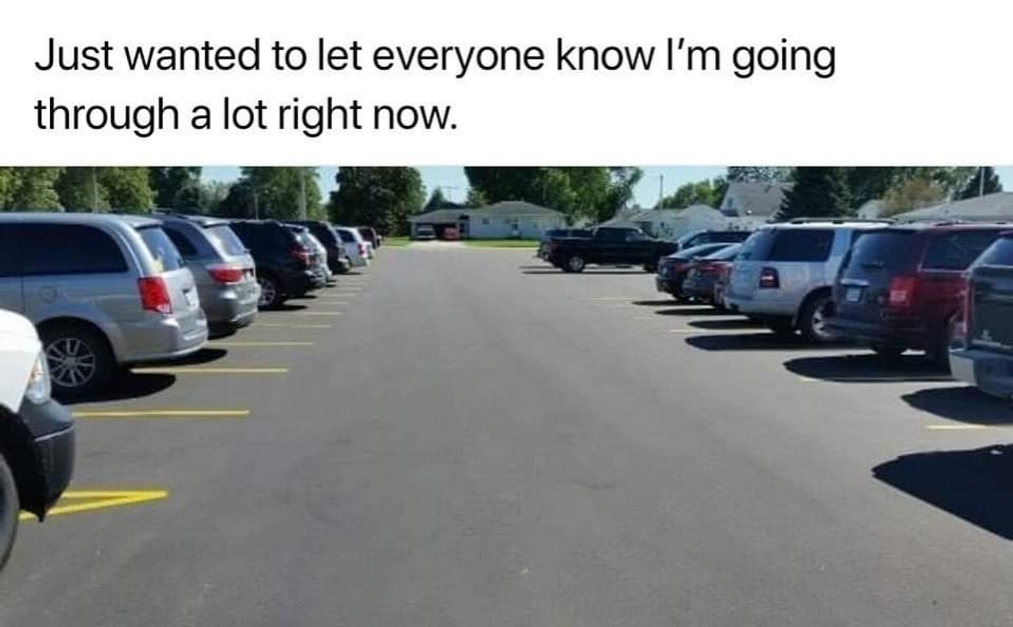 Text reads: Just wanted to let everyone know I'm going through a lot right now. 

Image: the view from inside a car driving through a parking lot full of cars. 