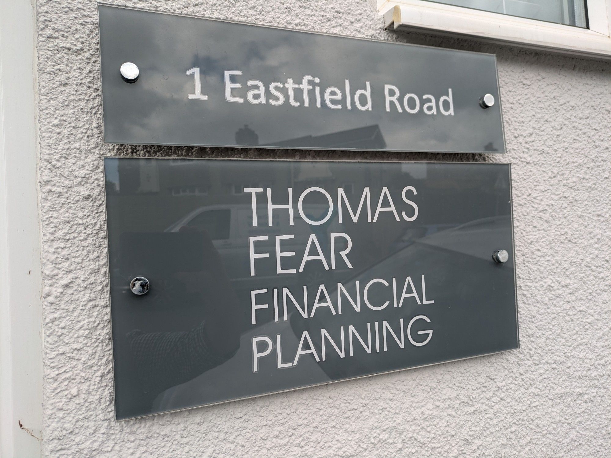 A sign outside an office advertising Thomas Fear Financial Planning.