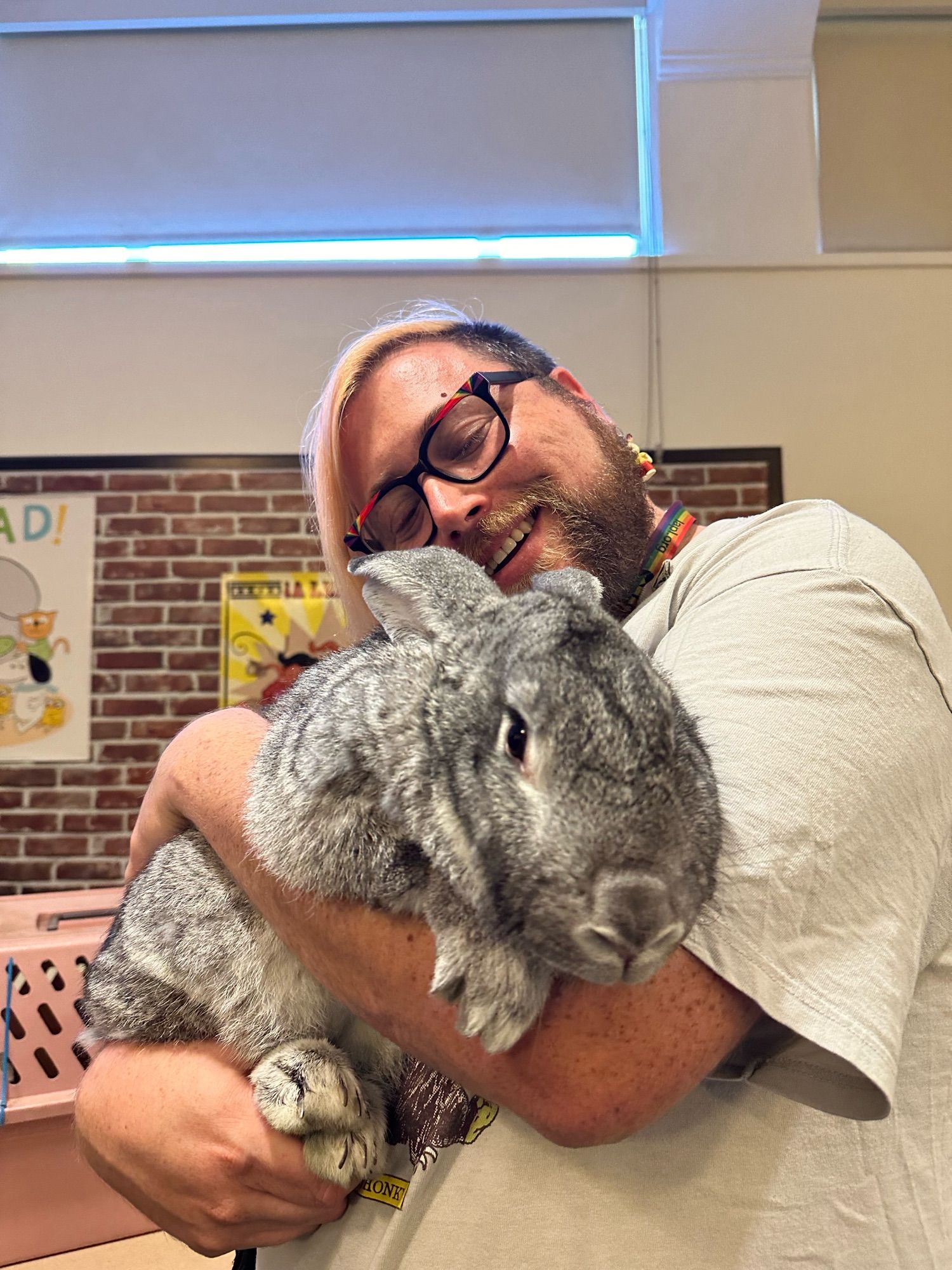 Vincey blissed out, snuggling the rabbit as they hold it like a baby.