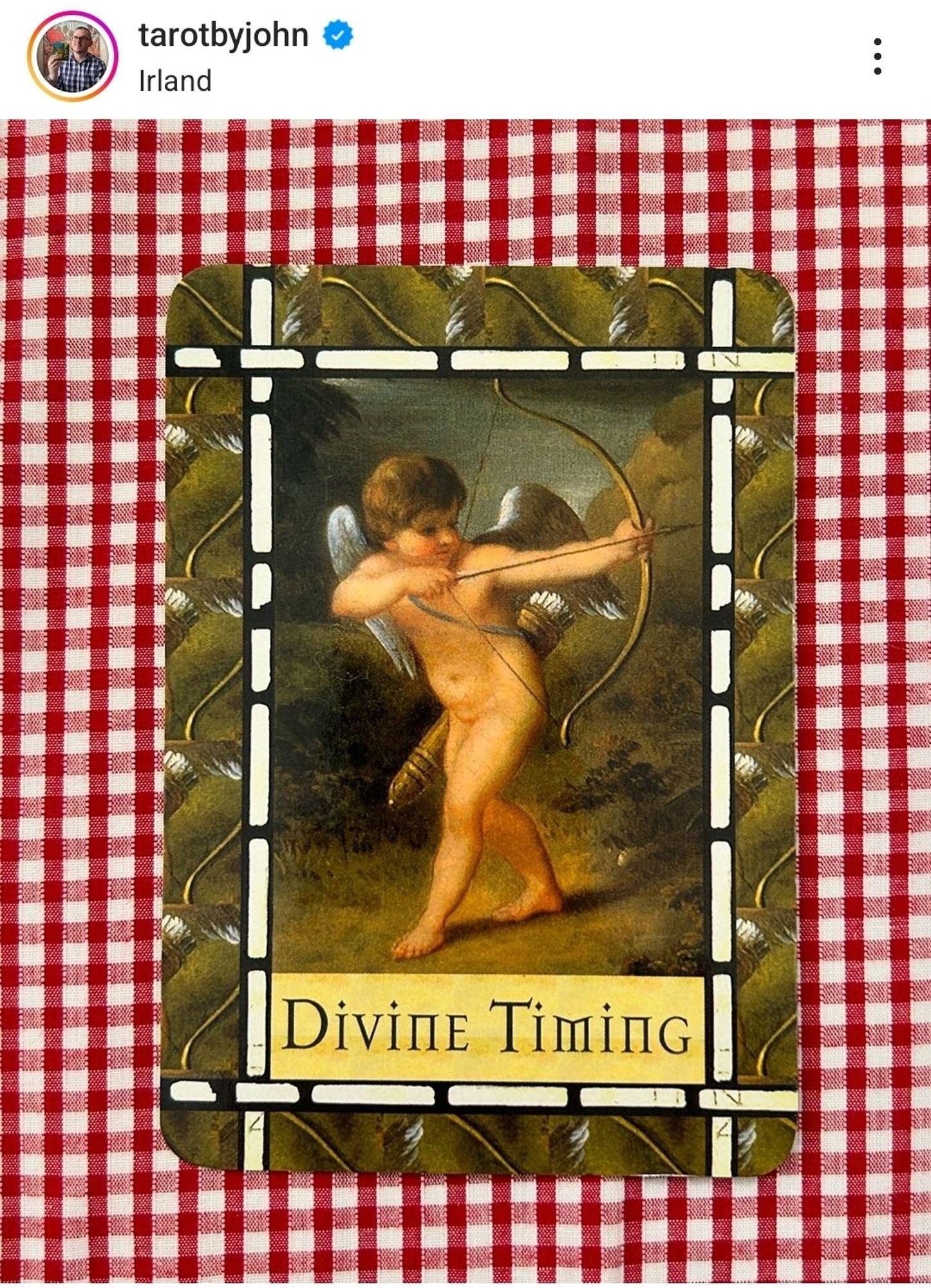 The picture shows an Oracle Card with a child/Angel holding a bow, ready to shoot. The Card says divine timing