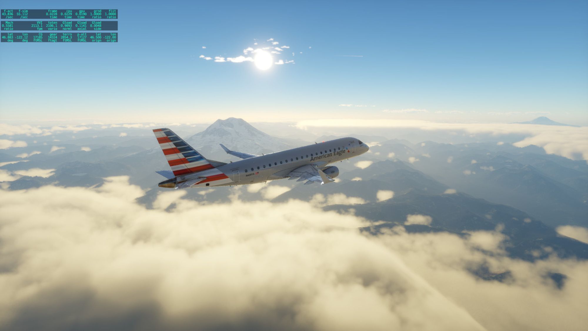 An Embraer 175 in American Eagle livery flies past Mount Ranier with Mount St. Helens looming in the background. It's a somewhat overcast day but blue, sunny skies above the clouds.