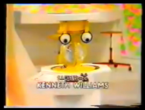 A v blurry screen shot of a plastic robot with sad googly eyes, captioned “starring Kenneth Williams”