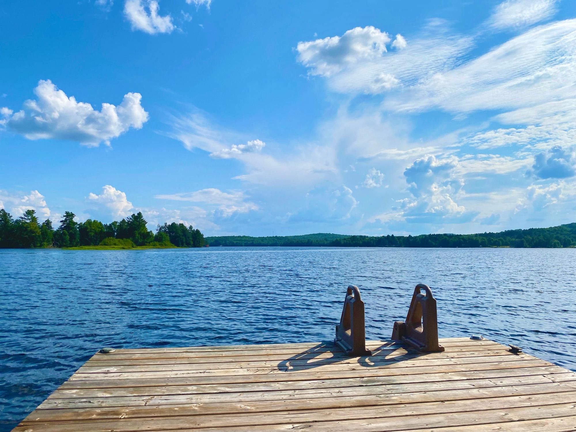 Looking down the dock at a gorgeous Canadian lake that makes you want to jump into it.