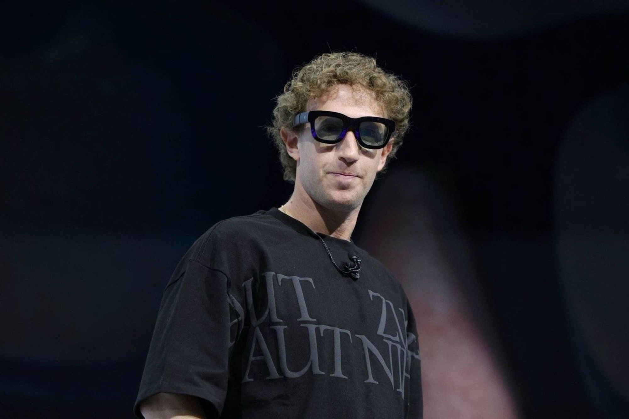 Mark Zuckerberg models Meta’s latest wearable technology spectacles in a custom t-shirt with Latin text graphics.