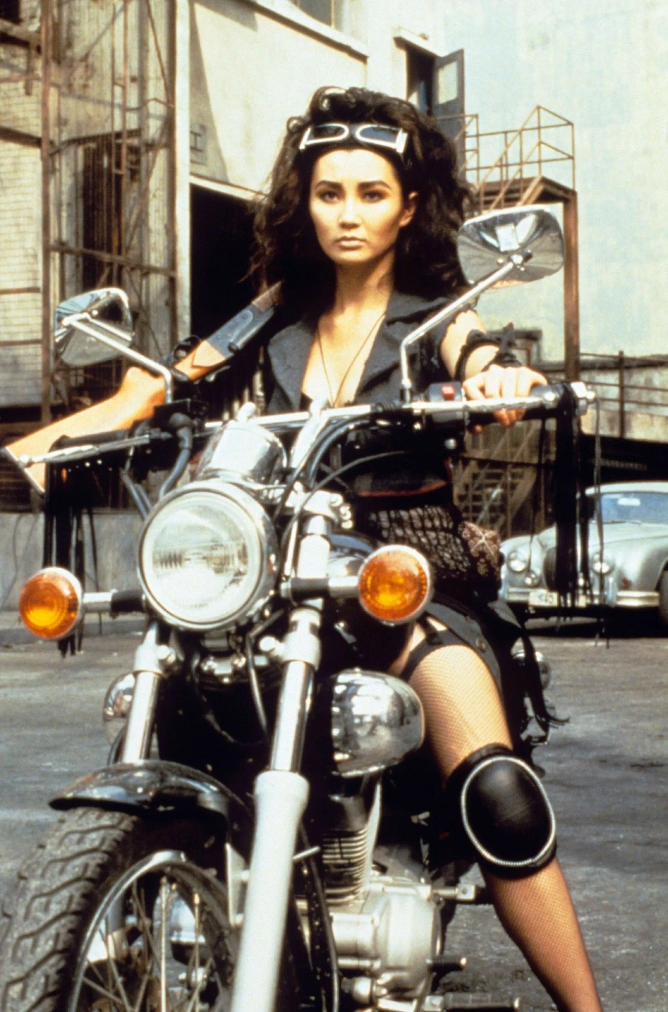 Maggie Cheung as Thief Catcher in a publicity photo. She's on a motorcycle.