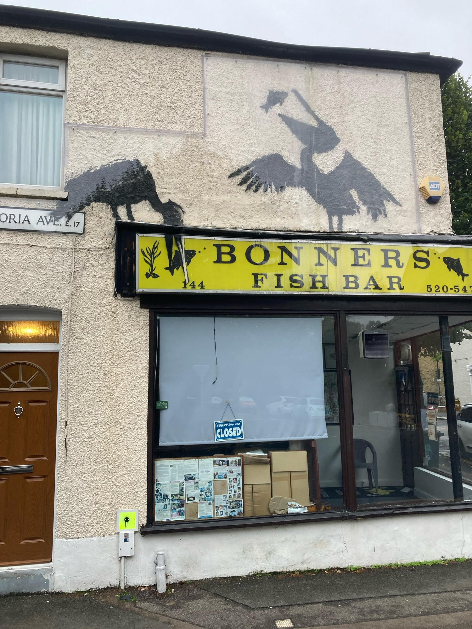 The frontage of Bonners Fish Bar in Walthamstow with Banksy’s illustration of a couple of pelicans eating fish. 