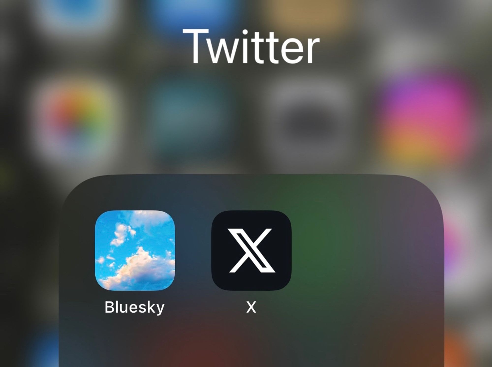 Screen shot of an iPhone folder named “Twitter” with the Bluesky and “X” apps in it.