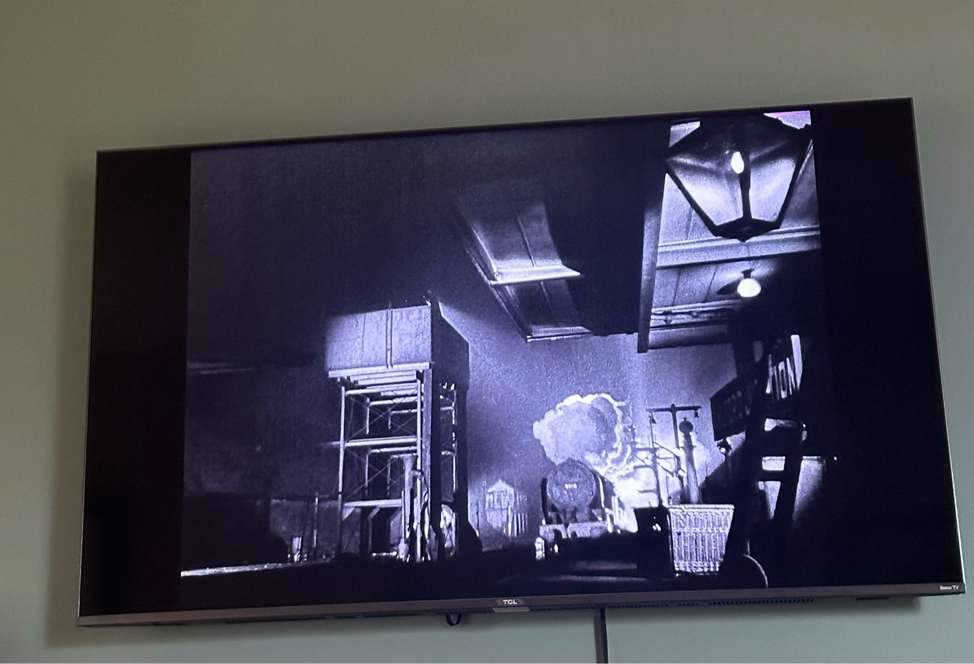 tv screen showing a b+w shot of a train arriving in a station with big poufs of steam around it in David Lean’s BRIEF ENCOUNTER (1945)