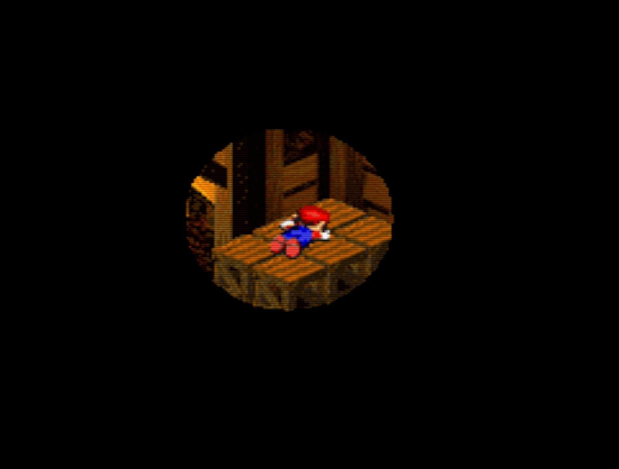 Screenshot of Super Mario RPG.  The whole screen is black except for a tunnel vision circle of Mario laying face down on some crates.