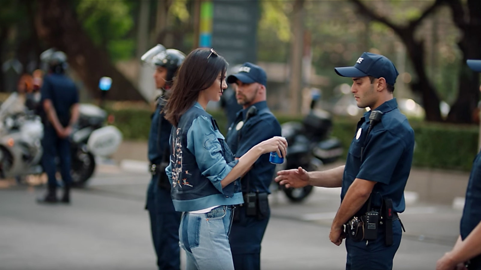 Kylie Jenner Pepsi ad where she is handing a pepsi to a police officer outside of a vauge protest