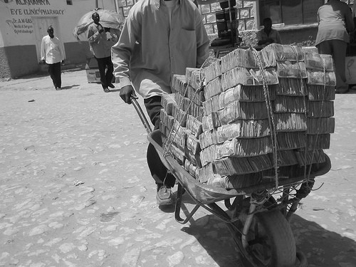 man in Weimar Republic Germany going to market with a wheelbarrow full of marks