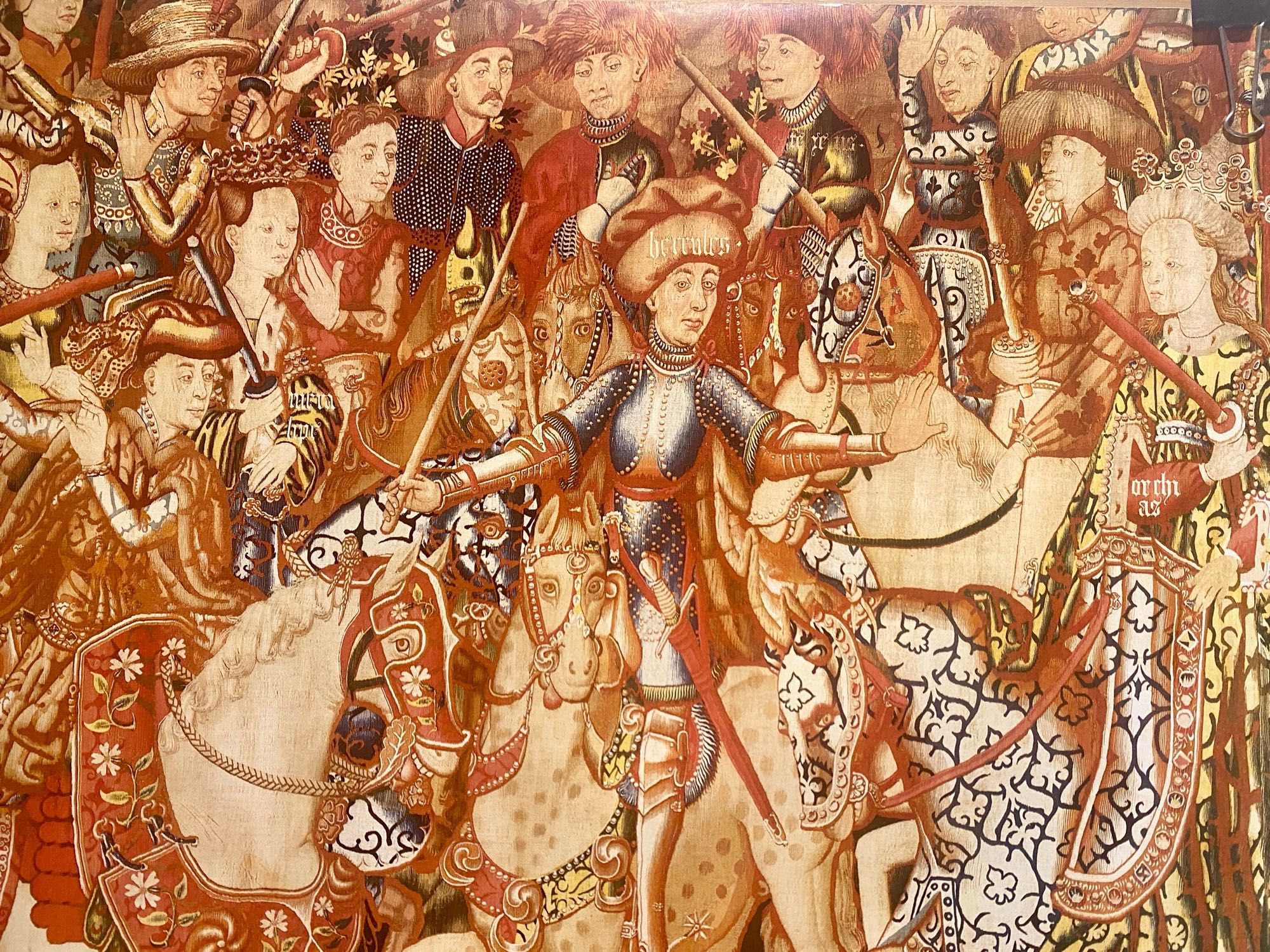 Medieval tapestry c1450 with shiny knight and randy horses.