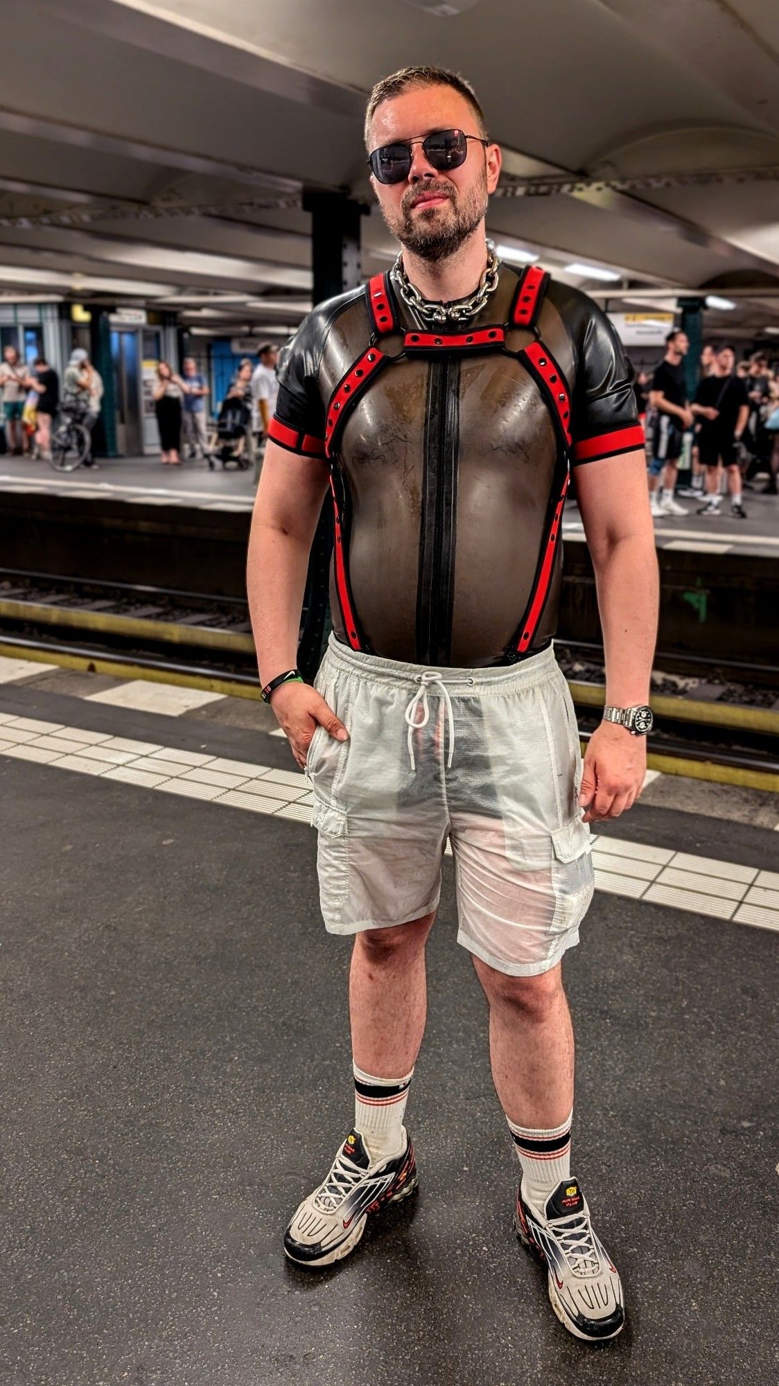 Man in rubber surf suit with neoprene harness and translucent shorts above