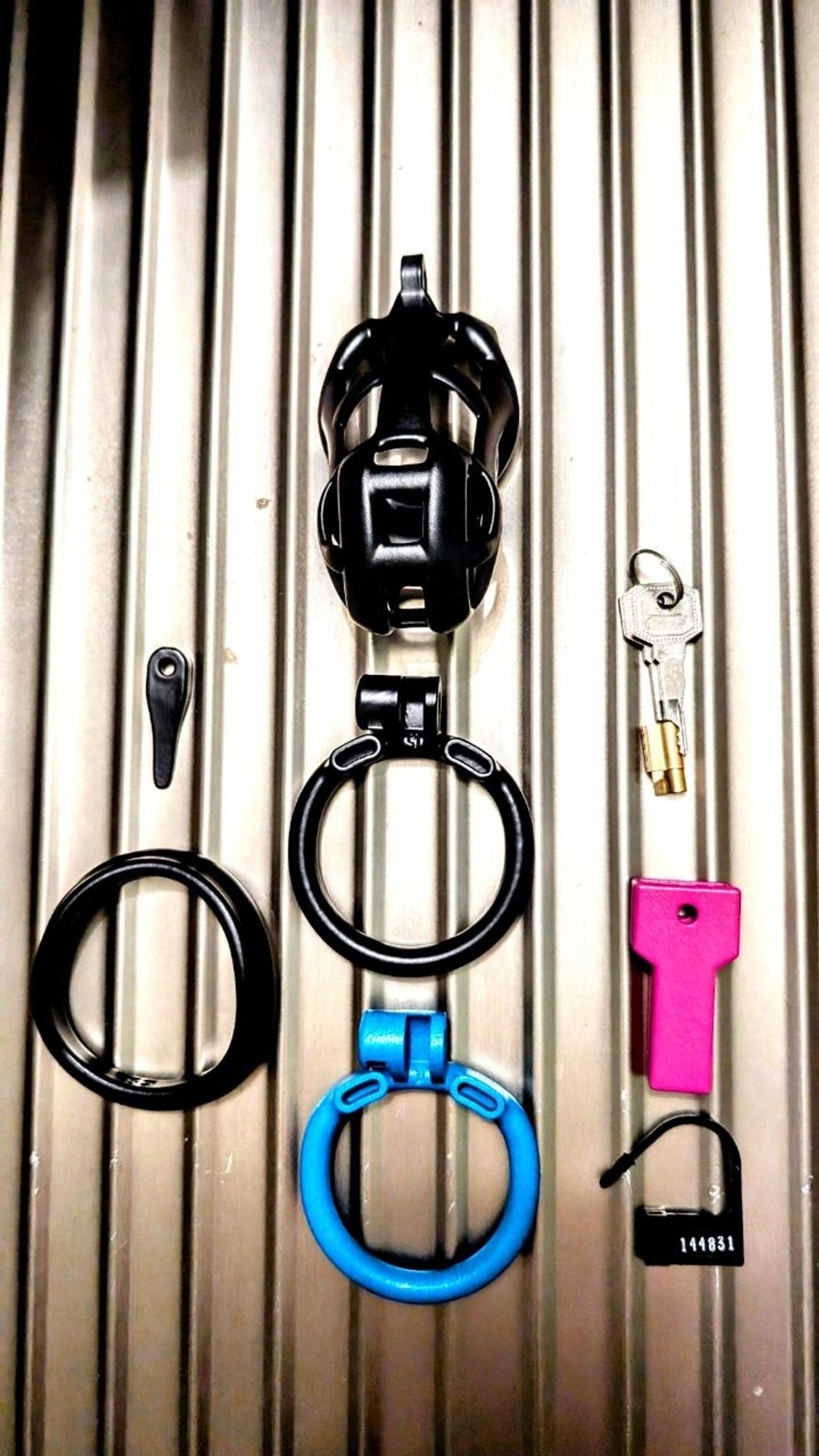 A chastity cage with various accessories