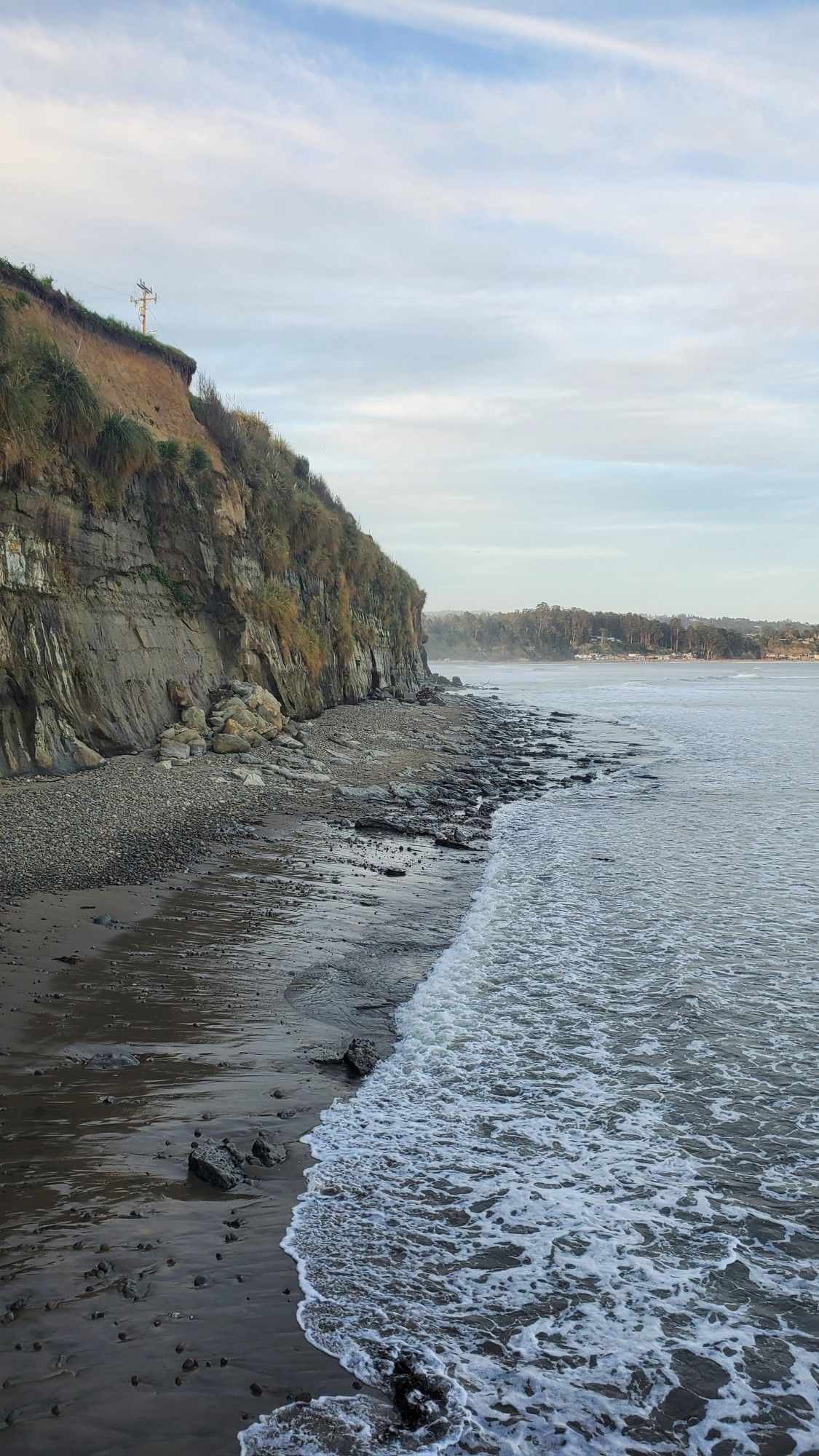 View facing East from Esplanade Park of the seaside cliffs overlooking a stretch of stone littered beach