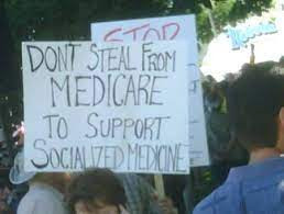 protest sign saying, "Don't Steal From Medicare To Support Socialized Medicine"