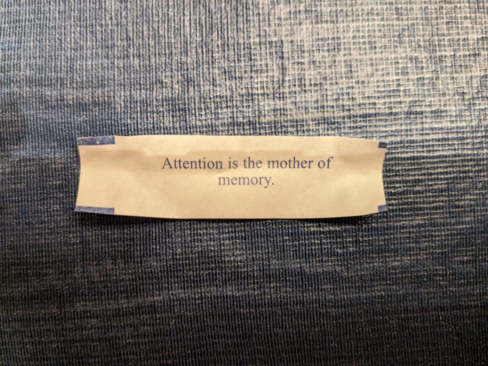 A fortune from a cookie that reads "Attention is the mother of memory"