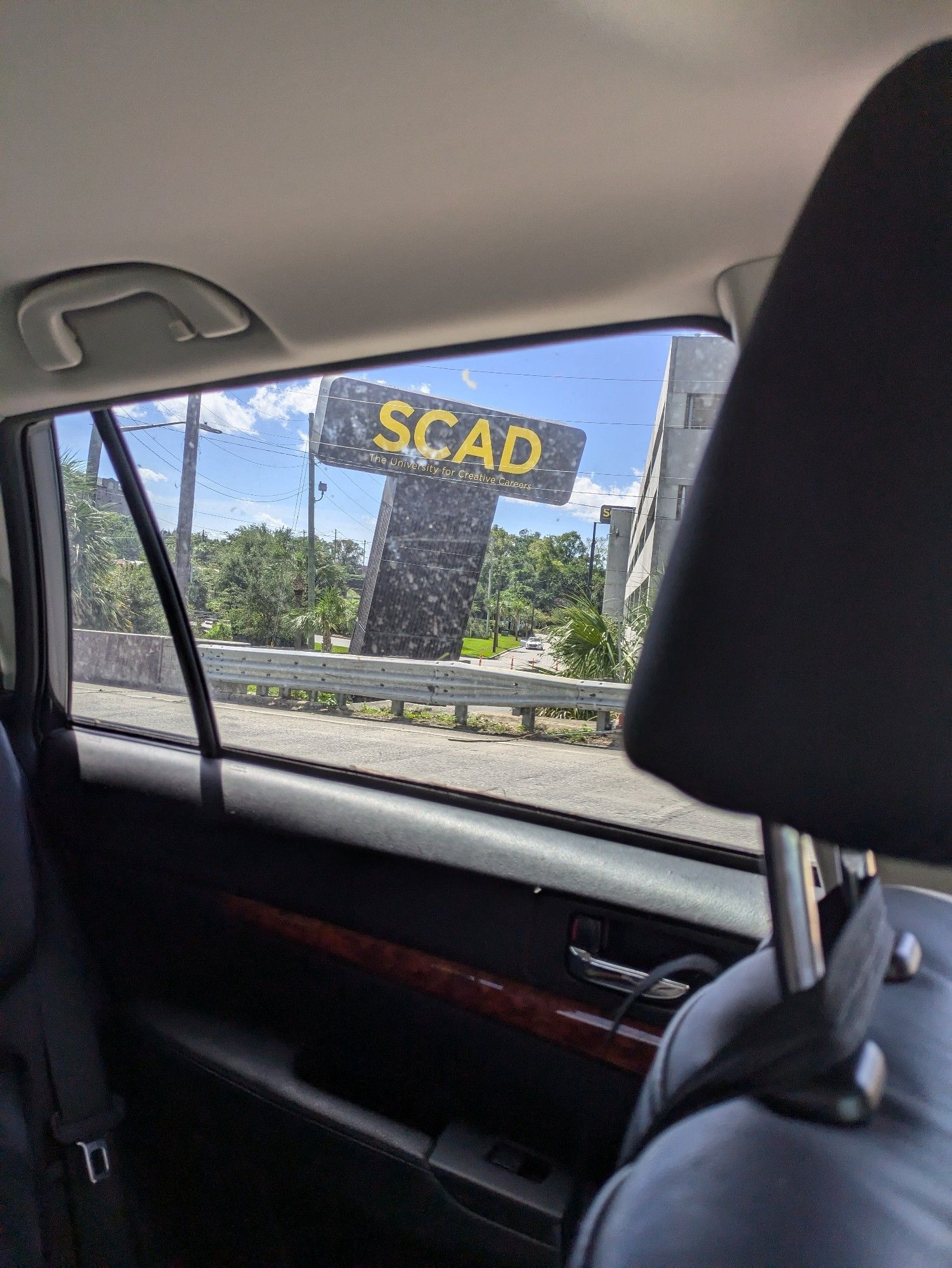 Really badly taken but fortunately timed photo of the SCAD sign partially knocked over along the entrance to the Talmadge Bridge. In frame is also the backseat of my sisters Subaru.