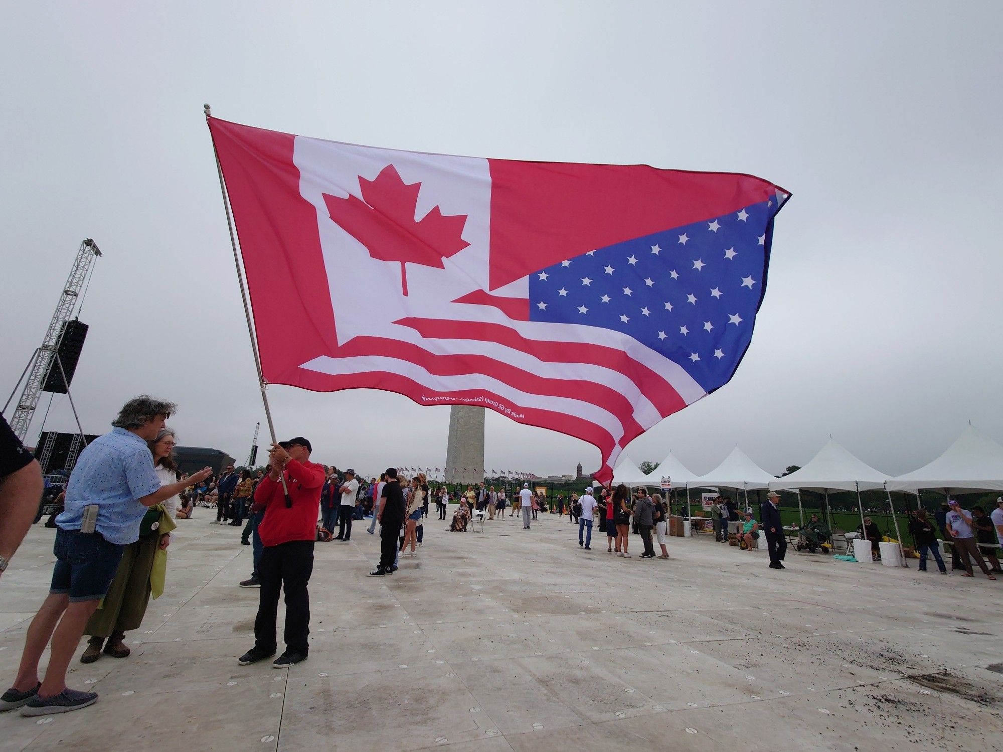 a guy with a big half canadian and half us flag but the proportions are way off