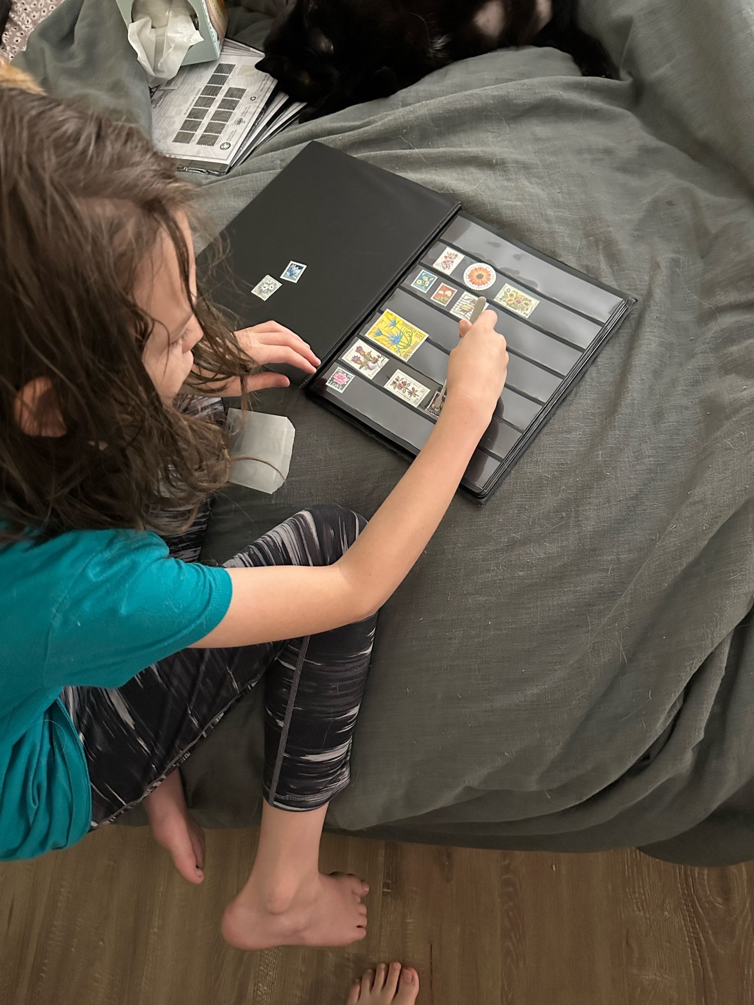 4th grader organizing her stamps