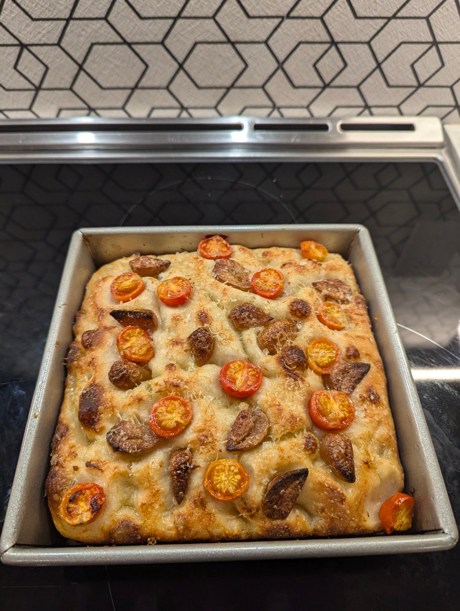 Bread after baking, showing off the roasted tomatoes and confit garlic