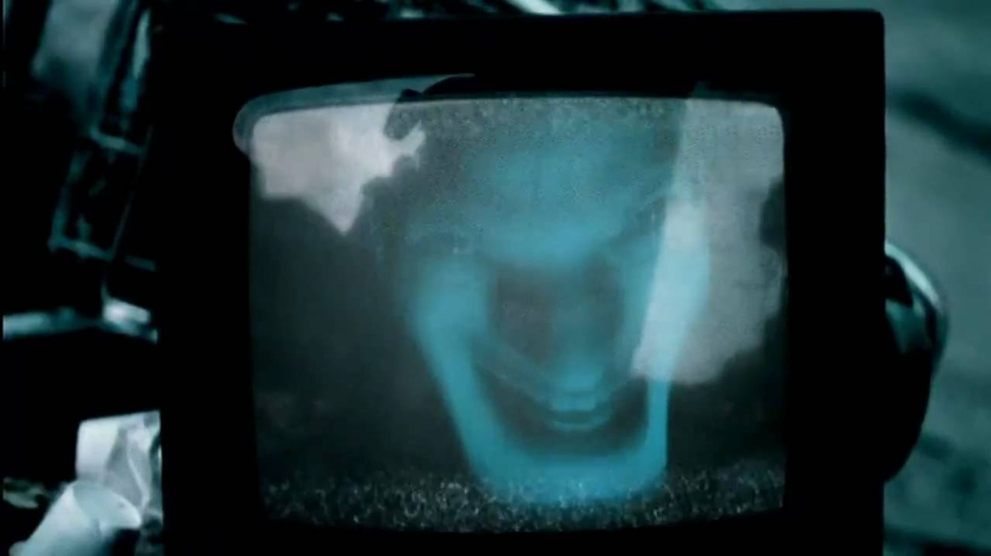 Video for Aphex Twin's "Come to Daddy" with Richard James' warped face on a TV screen