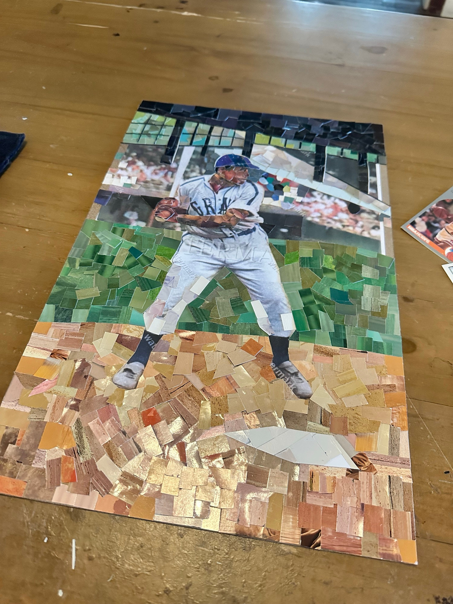 Josh Gibson mosaic in progress, made from cut baseball cards. 