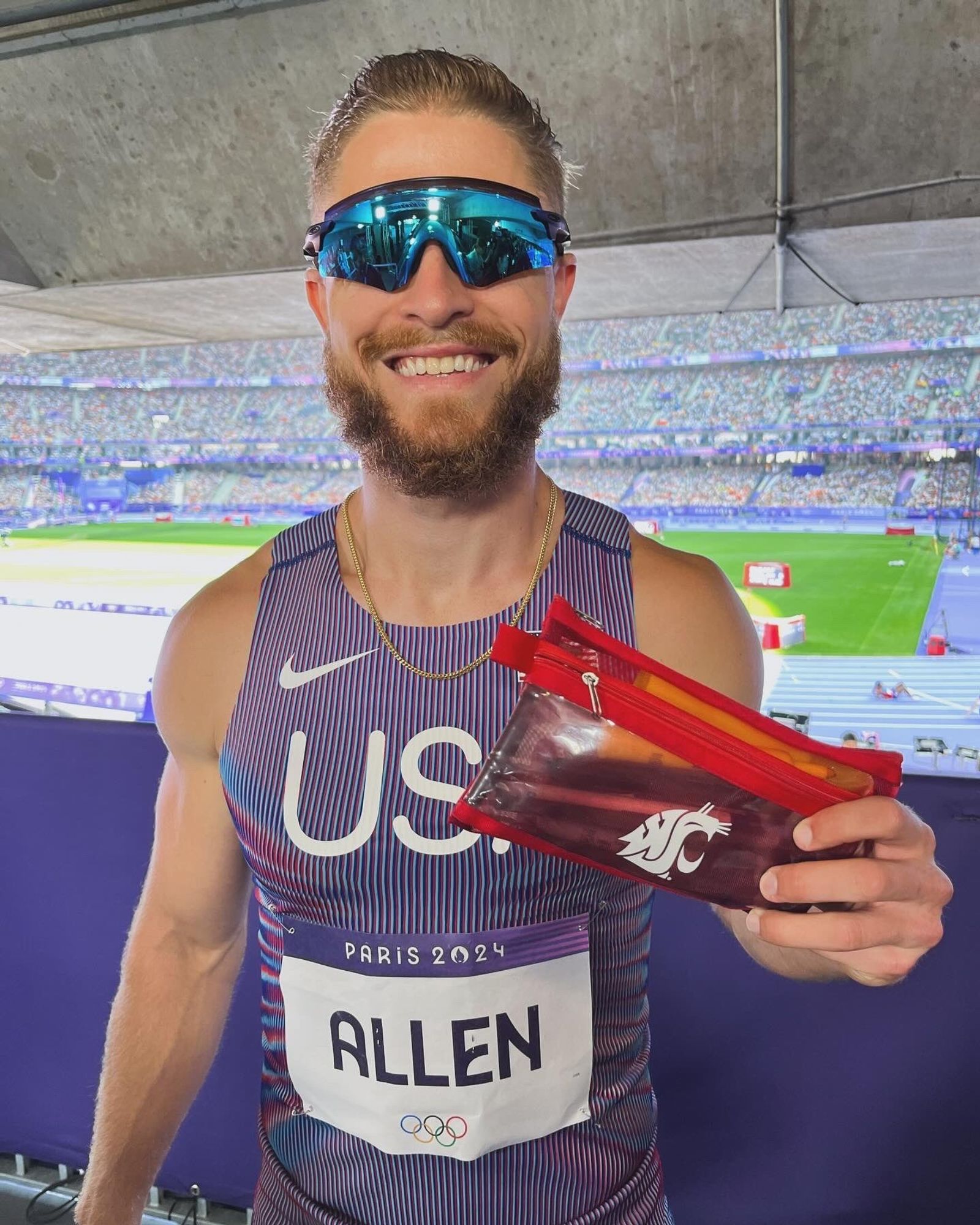 CJ Allen holding a WSU pencil pouch at the Paris 2024 Olympics