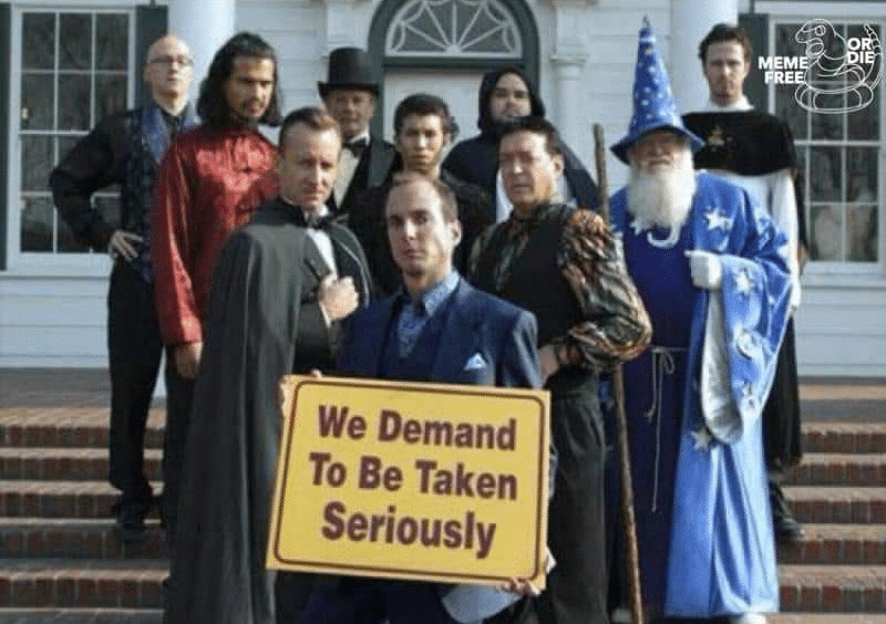 "We demand to be taken seriously"
is the sign that Gob holds in front of his magician friends