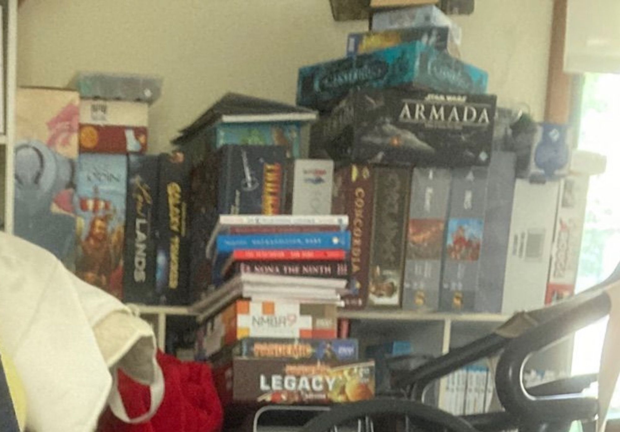 Picture of a bunch of board games, pandemic legacy, pandemic, star wars armada, concordia, galaxy traders, and a bunch of others that are hard to read the titles of