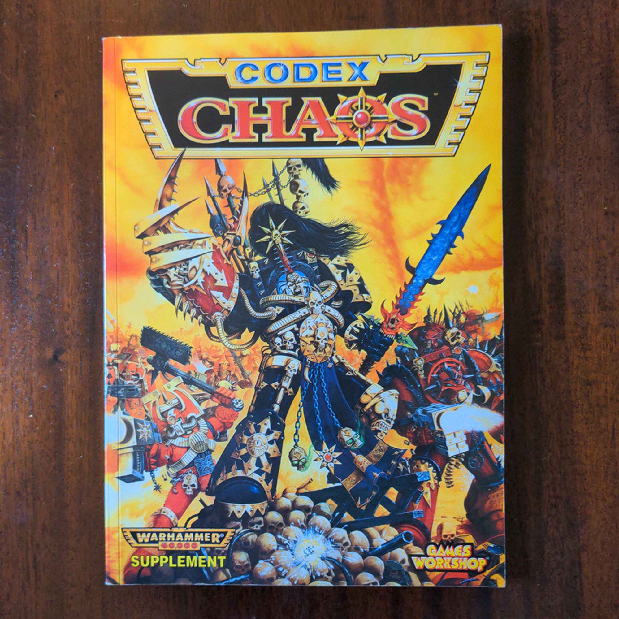 The 2nd edition Warhammer 40000 Chaos codex on a wooden table