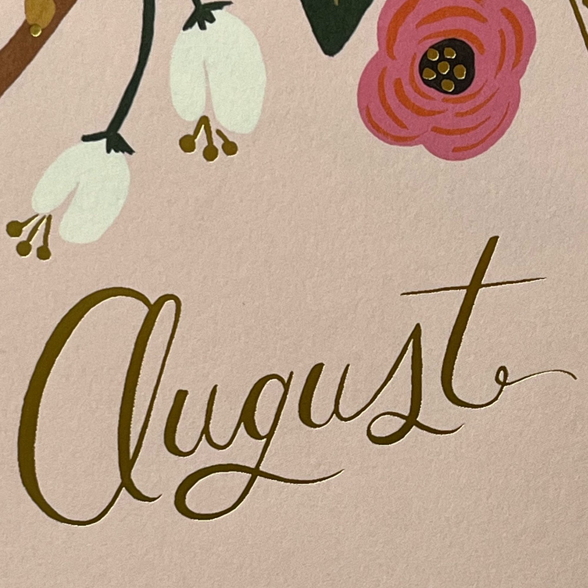 a closeup of a calendar page with the word “August” written in script but the A looks like Cl so it spells Clugust