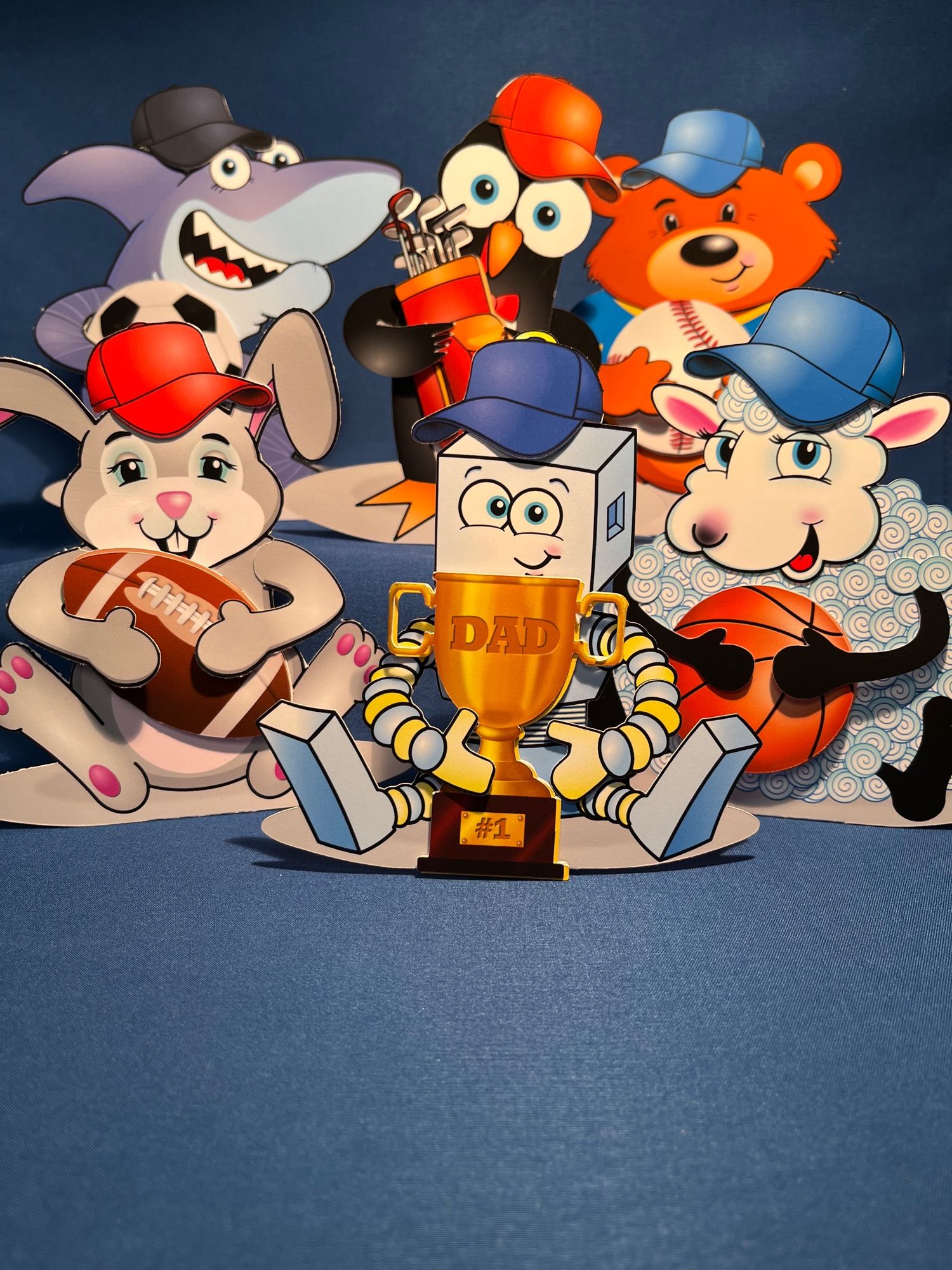 A group of self-standing cartoon characters wearing baseball caps and holding a variety of sports objects including a baseball, golf clubs and no. 1 dad trophy. 