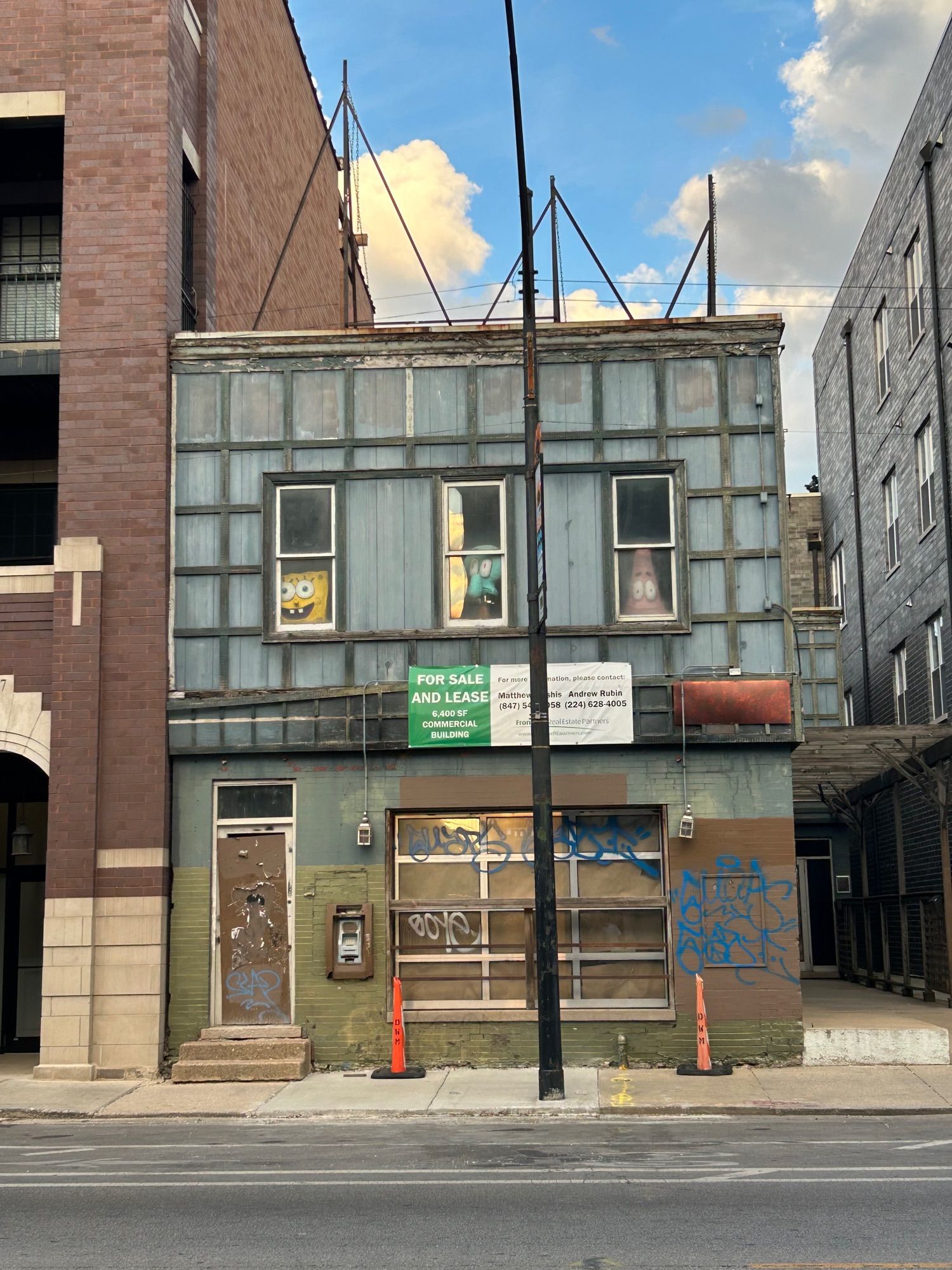 Old creepy 2-story building with “for lease” sign
There are three windows on the top floor with spongebob , squidward , and patrick in the windows . Each one more haggard than the last