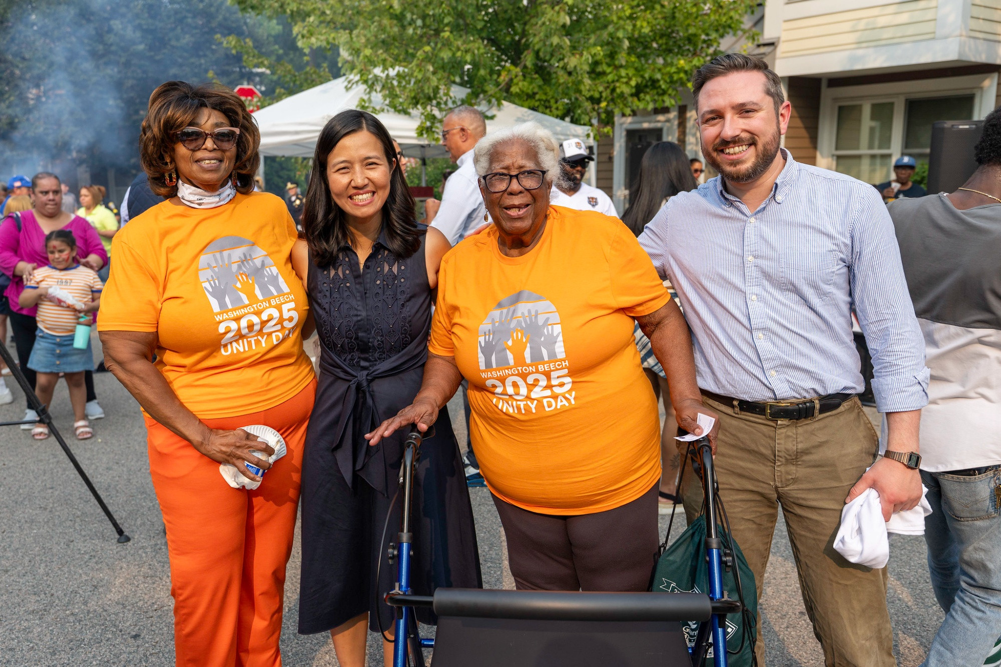 Josh McCorkle and Mayor Michelle Wu pose for a photo with community members
