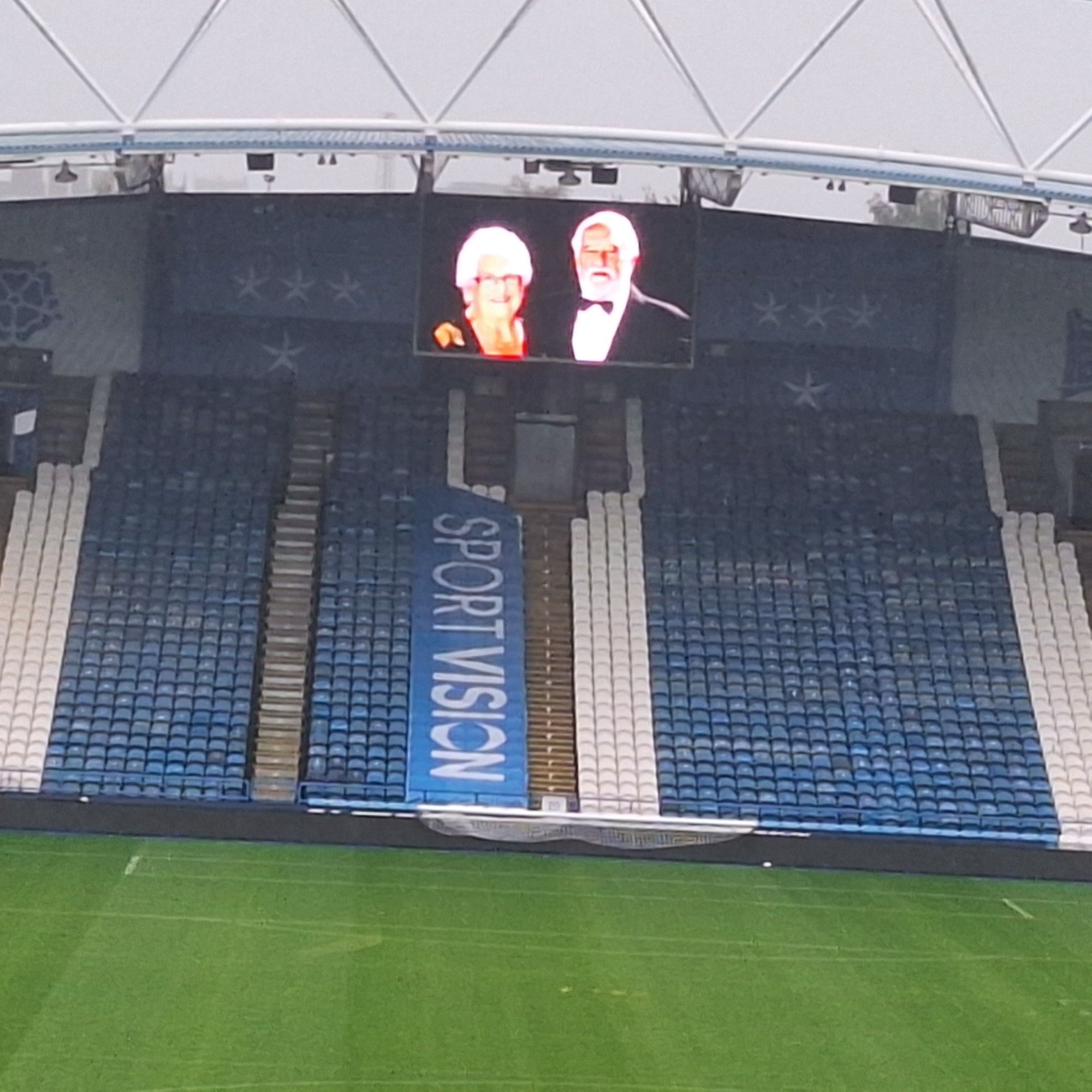 The away end of the local Football stadium in Huddersfield where the big screen has a picture of my grandparents