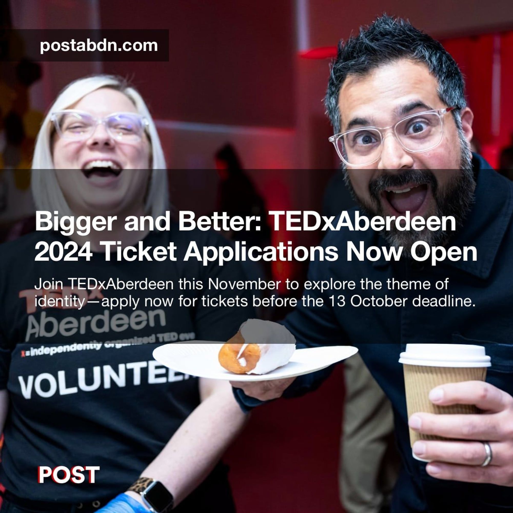 The image promotes TEDxAberdeen 2024 ticket applications. The text reads, "Bigger and Better: TEDxAberdeen 2024 Ticket Applications Now Open. Join TEDxAberdeen this November to explore the theme of identity—apply now for tickets before the 13 October deadline." The photo features two enthusiastic individuals, one holding a plate with a pastry and coffee, both smiling and wearing event attire, reflecting the lively and engaging atmosphere of the event. The background is filled with red lighting, adding to the vibrant energy.