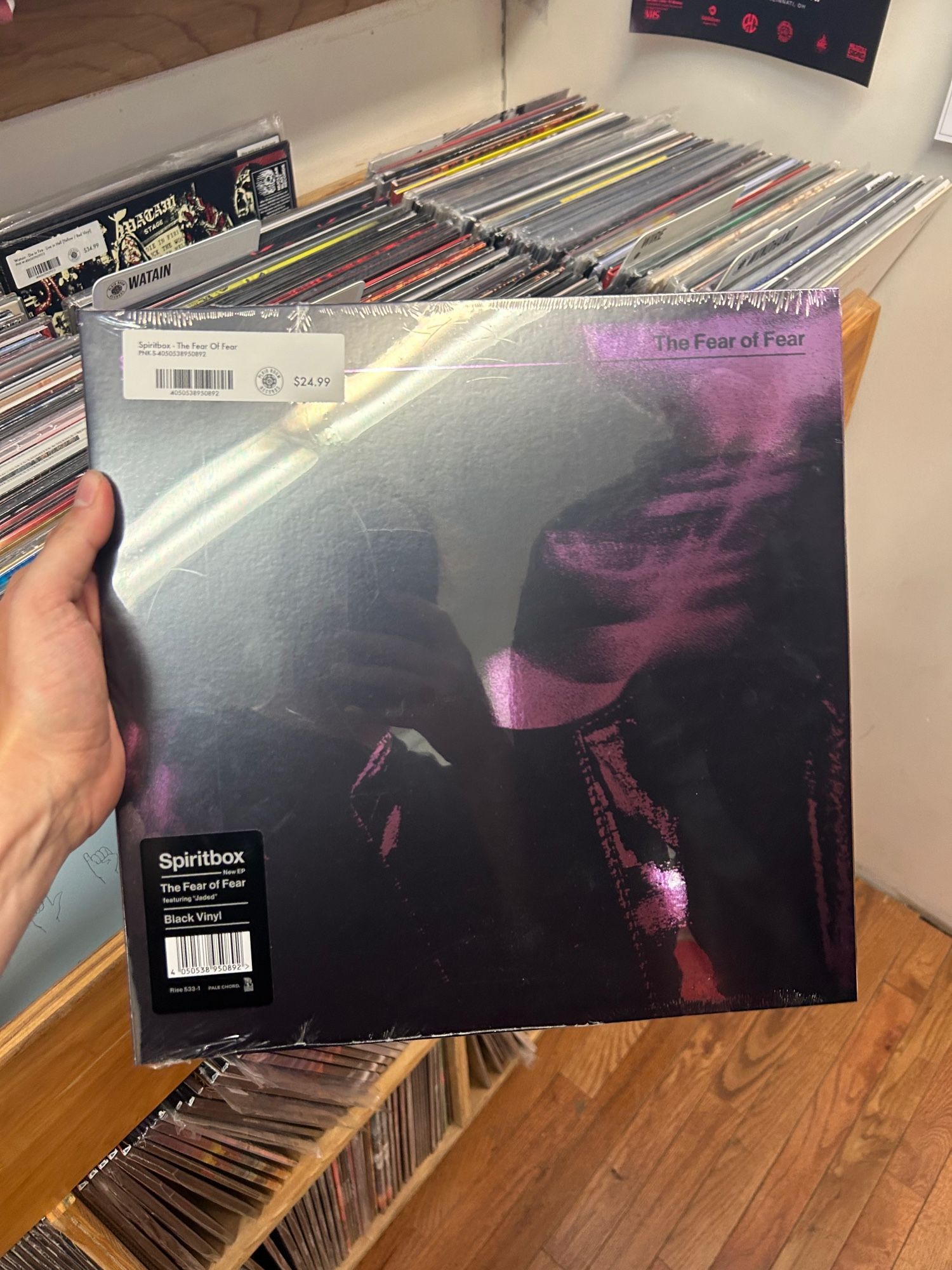 Me holding a vinyl record album that reads “spiritbox - the fear of fear” and a blurry purple image of a woman screaming