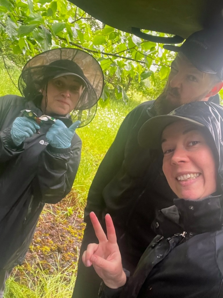 People hiding from the rain. Mostly smiling.