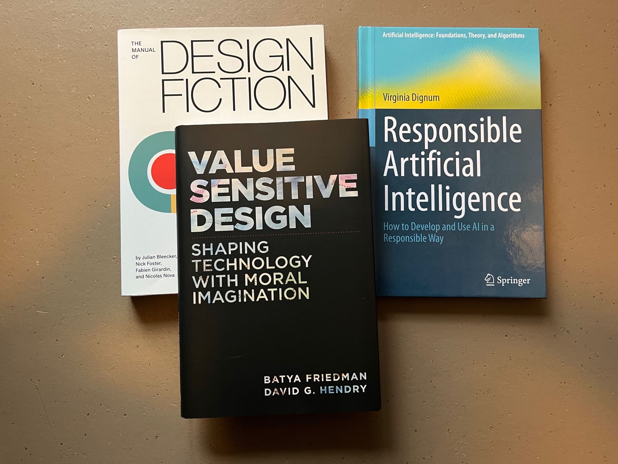 Three books: The Manual of Design Fiction (Bleecker et al., 2022), Value Sensitive Design (Friedman & Hendry, 2019), and Responsible Artificial Intelligence (Dignum, 2019).