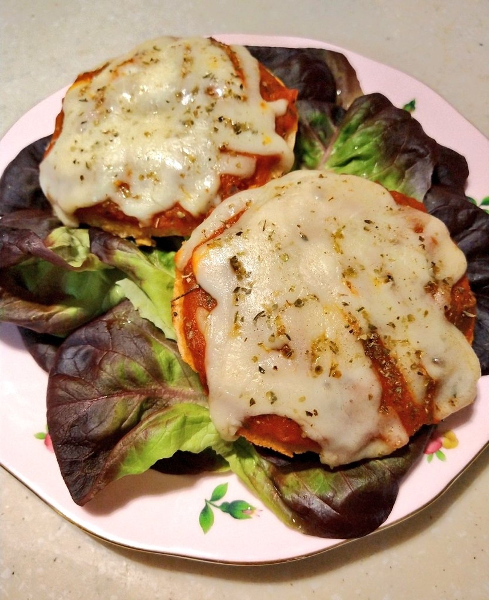 Royo low carb plain bagel with Rao Tomato Basil Sauce, Tillamook Italian blend cheese, and some Penzeys Italian Herb Mix seasoning, on a bed of Organic Girl baby greens + crunch. 
Paired it with some grapes and a bottle of Acqua Panna with lemon.