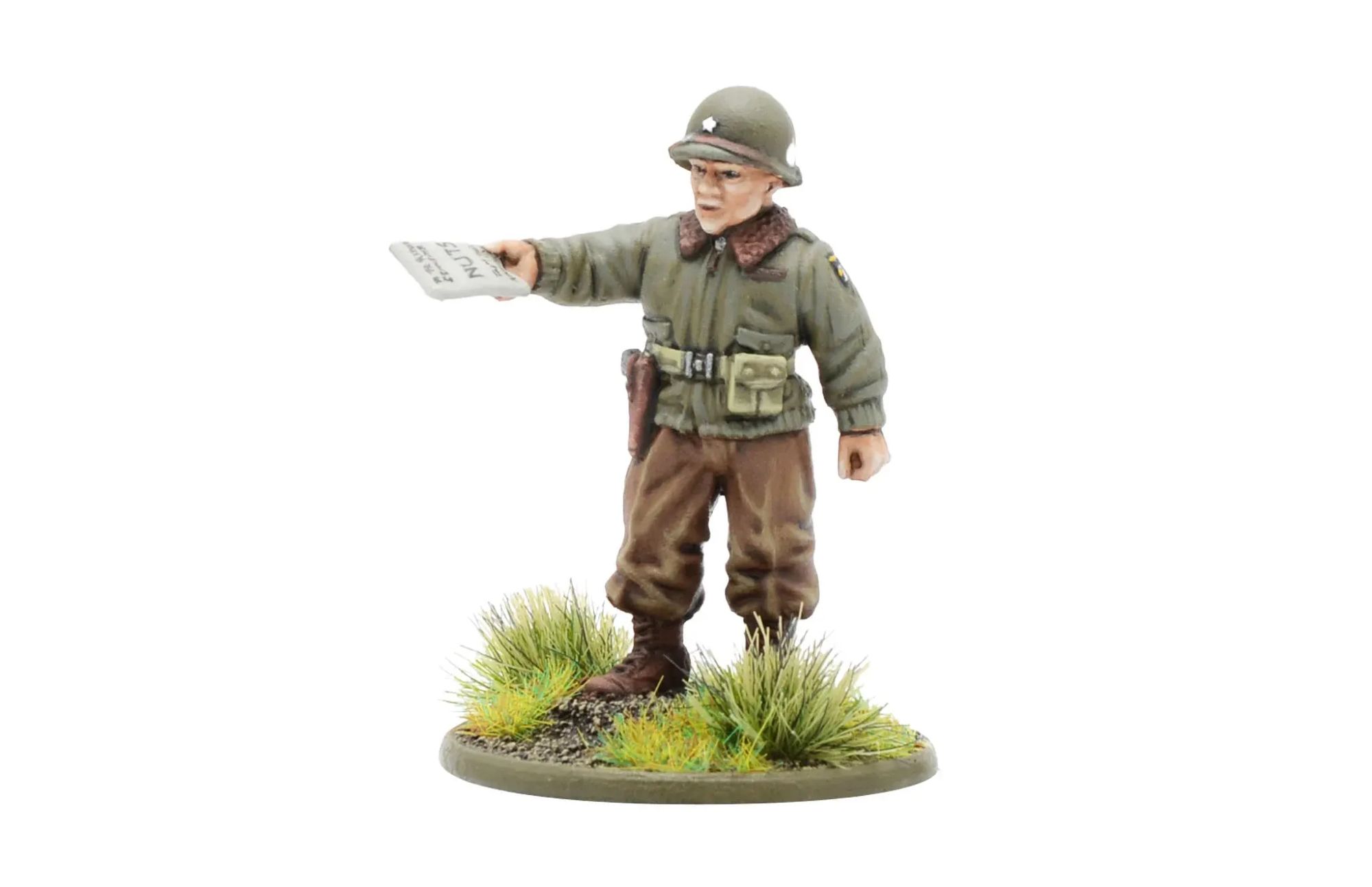 The image features a meticulously painted miniature figure of General Anthony McAuliffe, revealed by Warlord Games for their 2024 Open Day. The miniature presents a historical likeness of General McAuliffe during the Battle of the Bulge. The figure depicts a World War II soldier dressed in military attire, specifically a green uniform jacket, brown trousers, and a helmet. The general is holding a gun in his right hand, extending it forward as if giving an order or pointing. The miniature is posed standing on a circular base adorned with green grass and small plants, adding a realistic terrain element. This limited-edition miniature will only be available for purchase until September 22nd. https://tinyurl.com/364rrt6x