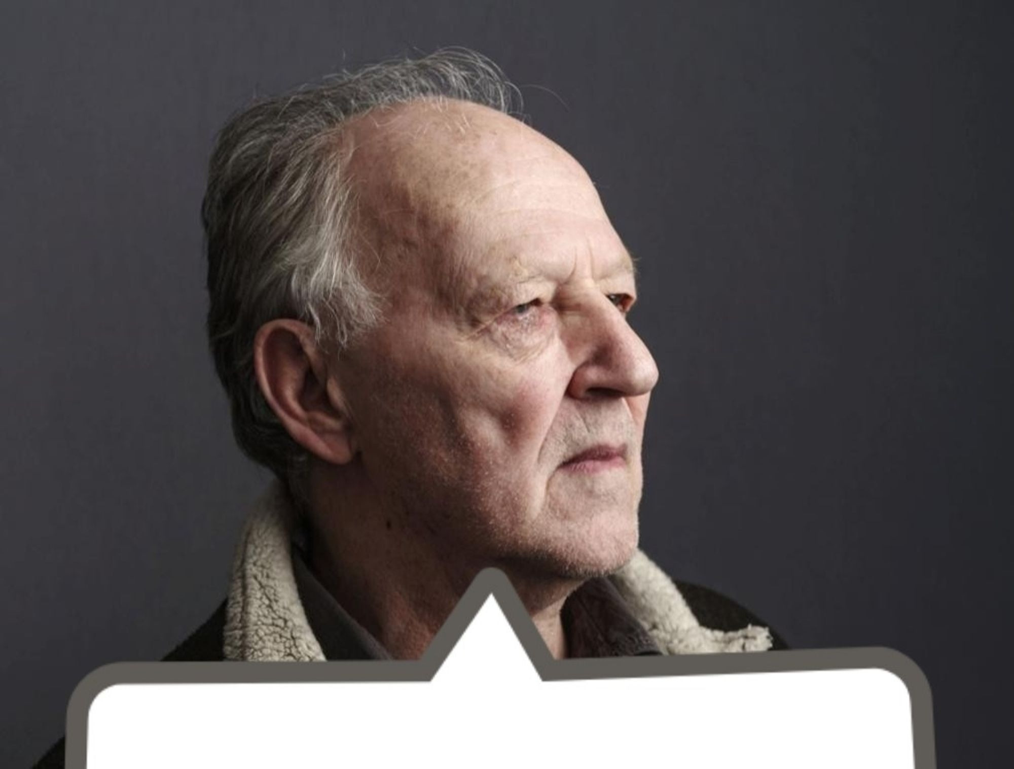 A picture of Warner Herzog looking to the side with an empty word bubble below him