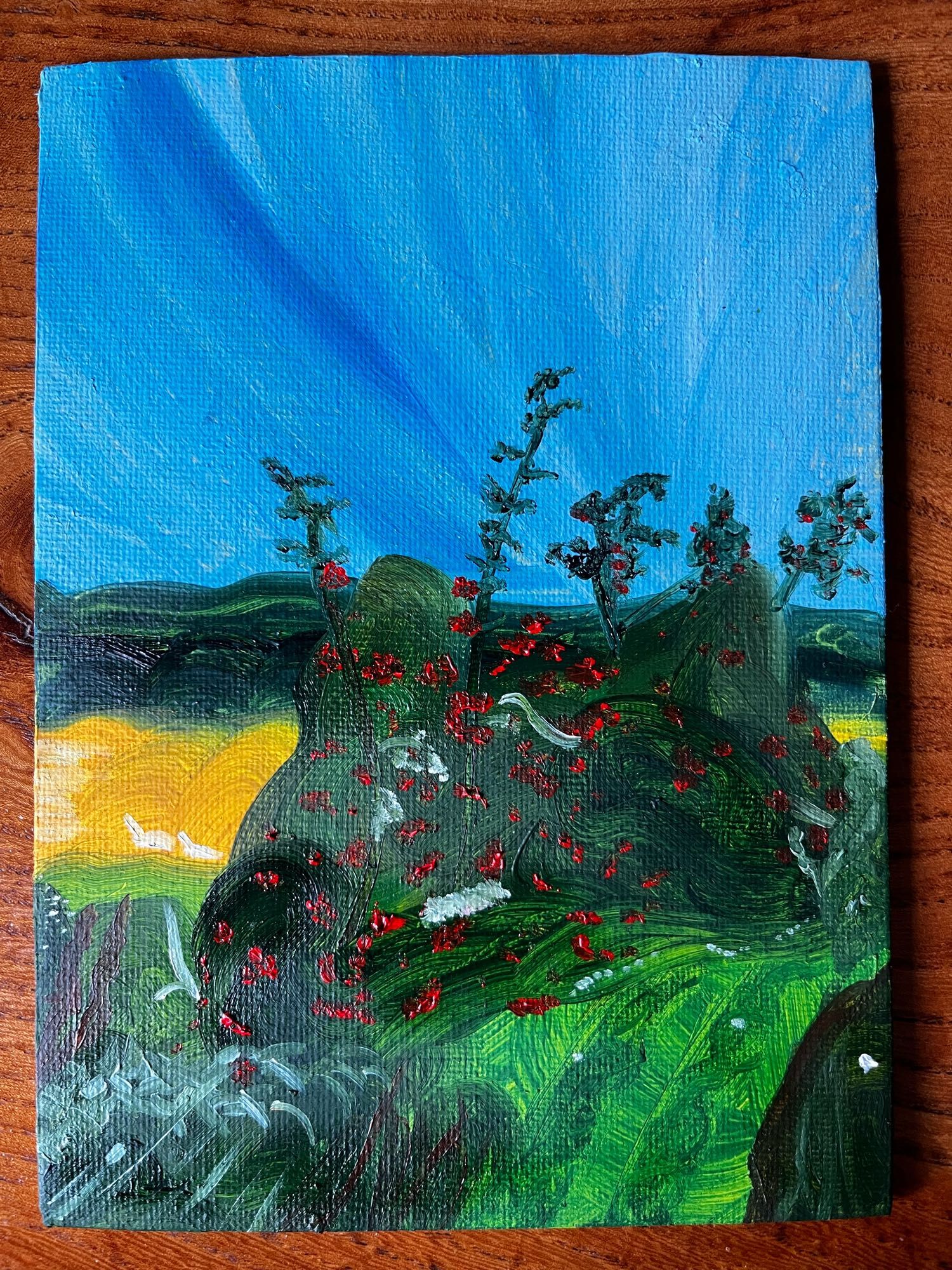 A landscape painted in oils, different greens and a big blue sky.