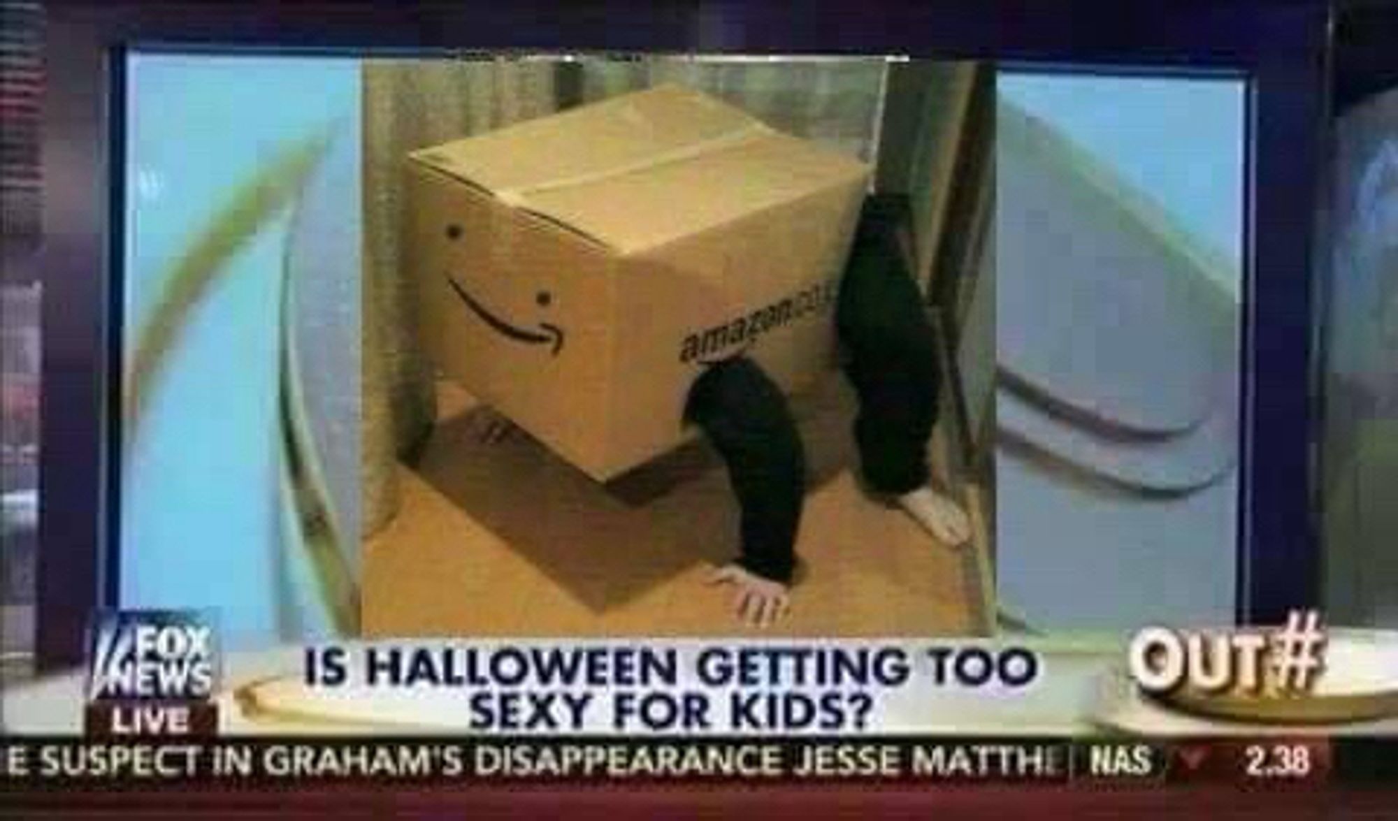 A fox Chyron that reads: “IS HALLOWEEN GETTING TOO SEXY FOR KIDS?” A man has crammed himself into an Amazon box on its logo looks like a smile. He is positioned in the box to have his arms and legs pop out of holes on its sides like a turtle. This person looks ridiculous