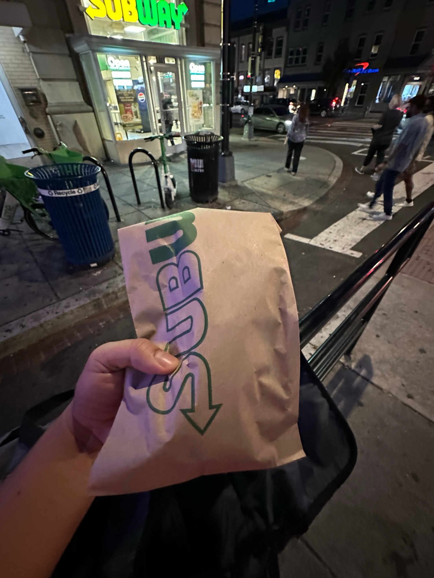 Me holding a subway sub outside a subway 