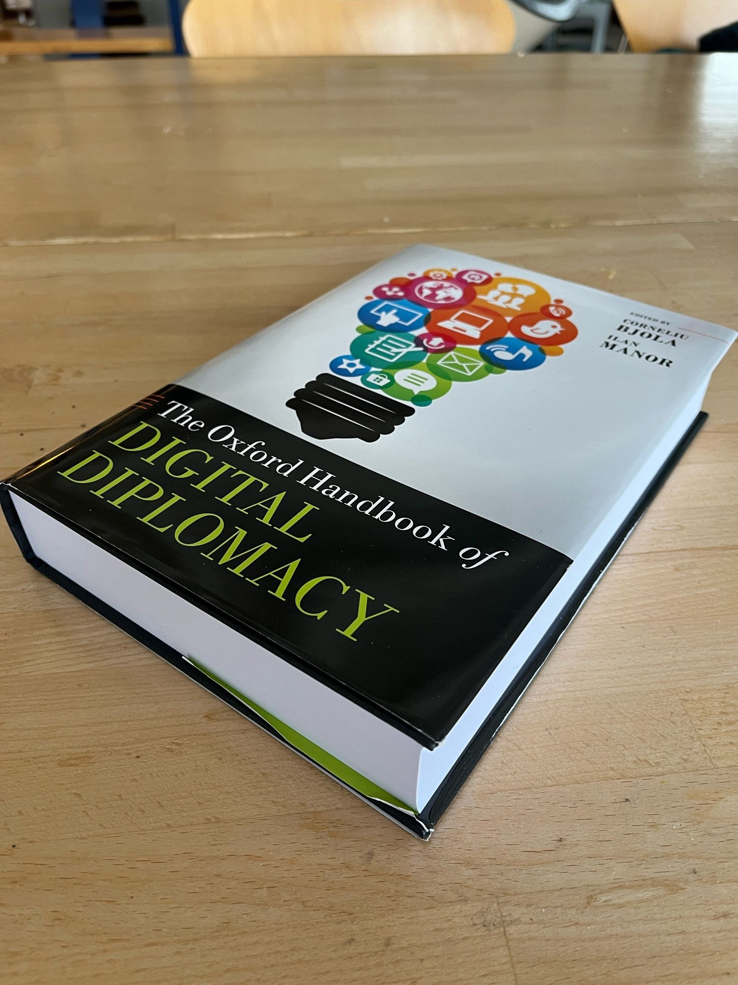 Close up of the 700-page Oxford Handbook of Digital Diplomacy on a table.